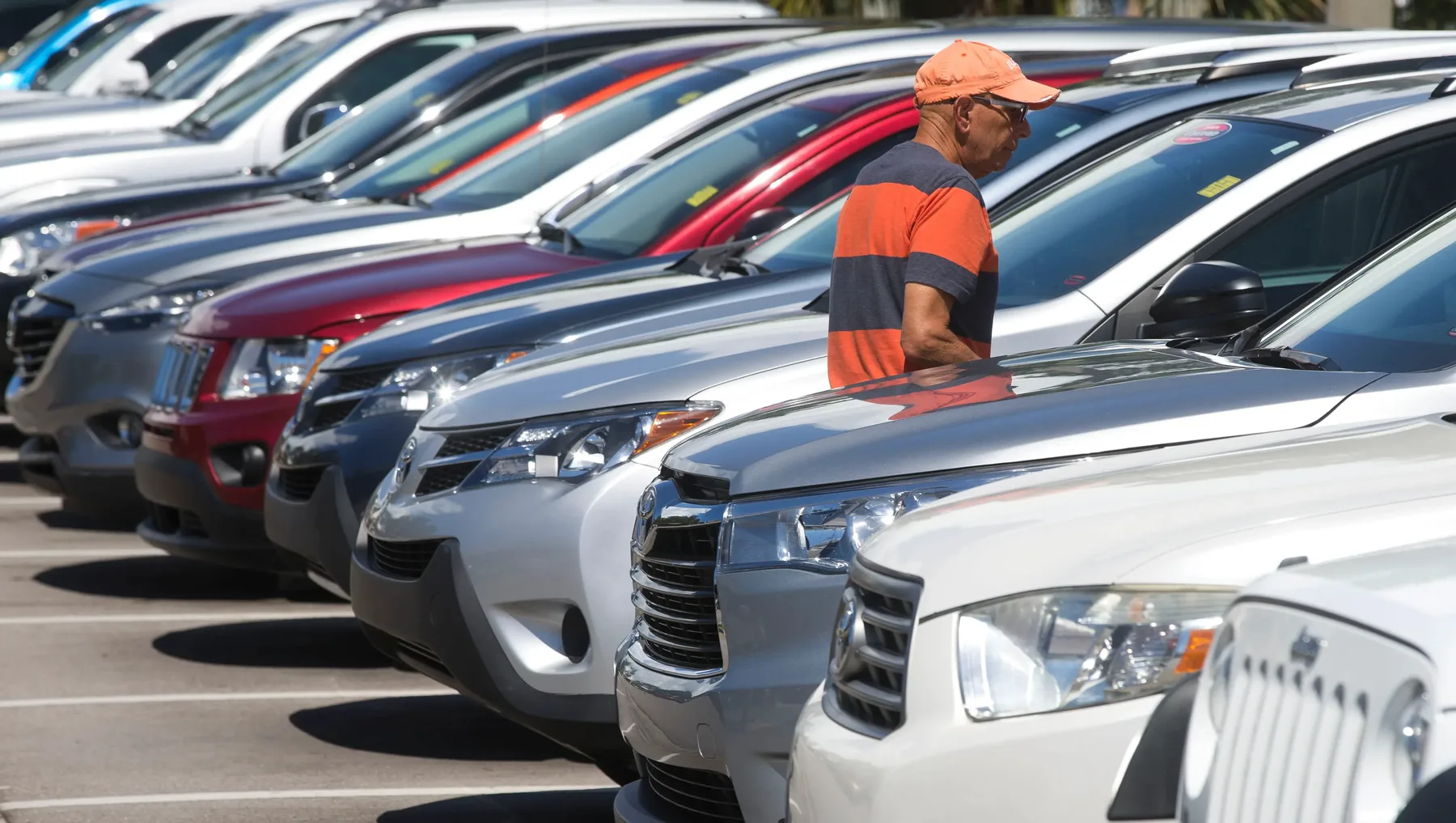 A team member checking cars on the lot