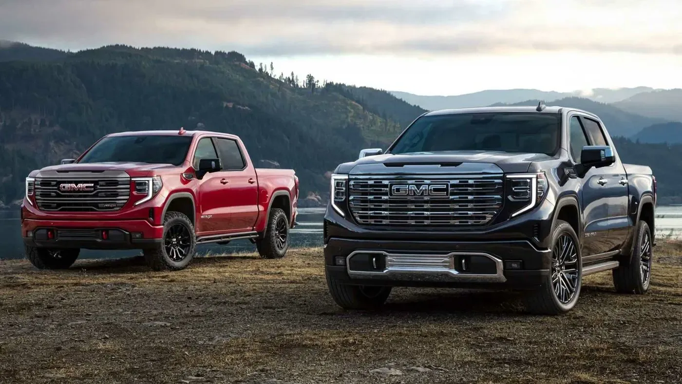 Two pickup trucks parked side by side outdoors